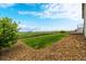 Backyard with a neatly mowed lawn and a charming split rail fence bordering a natural meadow at 42425 Forest Oaks Dr, Elizabeth, CO 80107