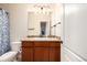 Bathroom with a light countertop vanity, mirror, and classic blue shower curtain at 42425 Forest Oaks Dr, Elizabeth, CO 80107