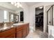 Bright bathroom featuring granite counters, tile floors, and a glass-enclosed shower near a spacious walk-in closet at 42425 Forest Oaks Dr, Elizabeth, CO 80107