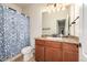 Bathroom features a light countertop vanity, mirror, and a blue patterned shower curtain at 42425 Forest Oaks Dr, Elizabeth, CO 80107