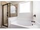 Corner bathroom features white tub with sleek fixtures and clear glass shower, creating a serene space at 42425 Forest Oaks Dr, Elizabeth, CO 80107
