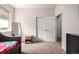 Bedroom featuring carpet floors, ample closet space, and a bright window at 42425 Forest Oaks Dr, Elizabeth, CO 80107