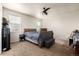Neutral bedroom featuring cozy carpet, a ceiling fan, and two windows, offering a relaxing retreat at 42425 Forest Oaks Dr, Elizabeth, CO 80107