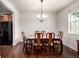 Dining room showcasing a classic chandelier, hardwood floors and marble tabletop, next to the kitchen at 42425 Forest Oaks Dr, Elizabeth, CO 80107