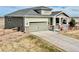 Charming two-story home with a gray roof, siding, a covered porch, and a spacious two-car garage at 42425 Forest Oaks Dr, Elizabeth, CO 80107