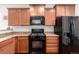 Close-up featuring stainless steel stove and appliances against wooden cabinetry and granite countertop at 42425 Forest Oaks Dr, Elizabeth, CO 80107