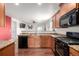 Open kitchen layout featuring granite countertops, wooden cabinets, and modern appliances, seamlessly connecting to other living areas at 42425 Forest Oaks Dr, Elizabeth, CO 80107