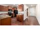 Traditional kitchen with dark cabinets, granite countertops, and stainless steel appliances offers a welcoming space at 42425 Forest Oaks Dr, Elizabeth, CO 80107