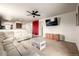 Open concept living room with white sectional, ceiling fan and view of the kitchen at 42425 Forest Oaks Dr, Elizabeth, CO 80107