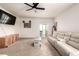 Cozy living room with ceiling fan, light beige carpet, and sliding glass door to the backyard at 42425 Forest Oaks Dr, Elizabeth, CO 80107