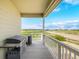 Inviting covered porch with outdoor grill, offering views of the tranquil surrounding landscape at 42425 Forest Oaks Dr, Elizabeth, CO 80107