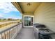 View of the shaded back porch with barbecue grill, ready for outdoor entertaining and relaxing at 42425 Forest Oaks Dr, Elizabeth, CO 80107