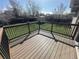 Inviting wooden deck with black metal railings overlooks a well-manicured lawn and fenced yard at 1592 S Memphis St, Aurora, CO 80017