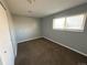 This bedroom features plush carpeting, neutral gray walls, and a window for natural light at 1592 S Memphis St, Aurora, CO 80017