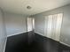 This bedroom features dark hardwood floors, a closet with folding doors, and neutral gray walls at 1592 S Memphis St, Aurora, CO 80017