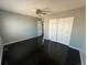 Comfortable bedroom featuring dark wood flooring, ceiling fan, and closet doors at 1592 S Memphis St, Aurora, CO 80017