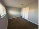 This bedroom features plush carpeting, neutral gray walls, and a closet with folding doors at 1592 S Memphis St, Aurora, CO 80017