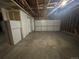 Spacious garage with exposed rafters, offering ample storage and parking for multiple vehicles and workshop space at 1592 S Memphis St, Aurora, CO 80017