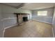 This living room features neutral-colored tile flooring and a fireplace with a decorative brick surround at 1592 S Memphis St, Aurora, CO 80017