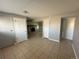 This living room has tile floors and multiple doorways and closets throughout the space at 1592 S Memphis St, Aurora, CO 80017