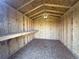 Interior of a shed with plywood walls and ceiling, with built-in shelving for added storage at 1592 S Memphis St, Aurora, CO 80017