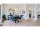 Inviting dining area features modern decor, stylish table with velvet chairs, and views into the kitchen at 2120 W 31St Ave, Denver, CO 80211