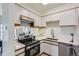 Well-lit kitchen featuring stainless steel appliances, white cabinetry, and quartz countertops, offering modern appeal at 2120 W 31St Ave, Denver, CO 80211