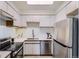 Modern kitchen equipped with stainless steel appliances, white cabinetry, and ample counter space, perfect for cooking at 2120 W 31St Ave, Denver, CO 80211