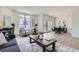 Spacious living area with a fireplace, hardwood floors, comfortable seating, and access to an outdoor patio at 2120 W 31St Ave, Denver, CO 80211