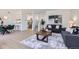 Open concept living area flowing into a kitchen with hardwood floors, modern furniture, and stylish decor at 2120 W 31St Ave, Denver, CO 80211