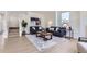 Open living area with hardwood floors, stylish sofas, and a large area rug creating a comfortable and modern living space at 2120 W 31St Ave, Denver, CO 80211