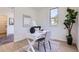 Home office with a white modern desk, stylish decor, and natural light from the window creating a productive workspace at 2120 W 31St Ave, Denver, CO 80211