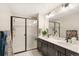 Modern bathroom featuring double sinks, updated countertops, and a glass-enclosed shower at 8811 Meade St, Westminster, CO 80031