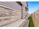 Exterior view of the home's backyard patio, fence, and stone accents at 8811 Meade St, Westminster, CO 80031