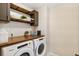 Functional laundry room with modern appliances, built-in shelving, and countertop space at 8811 Meade St, Westminster, CO 80031