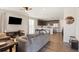 Open living area features hardwood floors connecting a modern kitchen, dining area, and a cozy living space at 8811 Meade St, Westminster, CO 80031