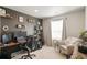 Well-lit home office space featuring built-in shelves and comfortable seating near a bright window at 8811 Meade St, Westminster, CO 80031