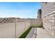 A cozy fenced-in patio features artificial turf, concrete pavers, and exterior stone accents at 8811 Meade St, Westminster, CO 80031