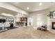 Finished basement with carpeted floors, fireplace, wet bar, and exercise equipment at 2486 S Monroe St, Denver, CO 80210