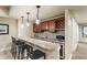 Basement wet bar featuring granite counters, wood cabinets, wine rack, and bar stool seating at 2486 S Monroe St, Denver, CO 80210