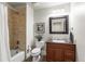Cozy bathroom featuring tiled shower and vanity with granite counters at 2486 S Monroe St, Denver, CO 80210