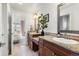 Bathroom featuring dual vanity, granite counters, and access to bedroom at 2486 S Monroe St, Denver, CO 80210