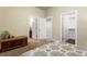 Bedroom with neutral walls and carpeted floor showing access to walk-in closet and bathroom at 2486 S Monroe St, Denver, CO 80210