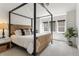 Bright bedroom with a black poster bed frame and a window for natural lighting at 2486 S Monroe St, Denver, CO 80210