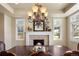 Elegant dining room featuring a fireplace, large windows, and a decorative chandelier at 2486 S Monroe St, Denver, CO 80210