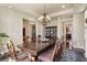 Spacious dining room with hardwood floors, decorative chandelier, and access to multiple rooms at 2486 S Monroe St, Denver, CO 80210