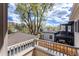 Exterior balcony view overlooking well-kept lawns and gardens, with garage and backyard patio visible at 2486 S Monroe St, Denver, CO 80210
