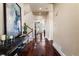 Inviting hallway with hardwood floors, recessed lighting, and a console table with decorative accents at 2486 S Monroe St, Denver, CO 80210