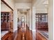 Elegant hallway with gleaming hardwood floors, recessed lighting, and decorative columns leading to other rooms at 2486 S Monroe St, Denver, CO 80210