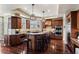 A spacious kitchen boasts wood cabinets, granite countertops, and stainless steel appliances, with an island and seating for four at 2486 S Monroe St, Denver, CO 80210